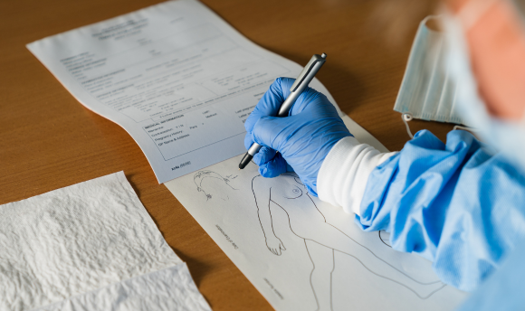 An image of a forensic nurse taking notes