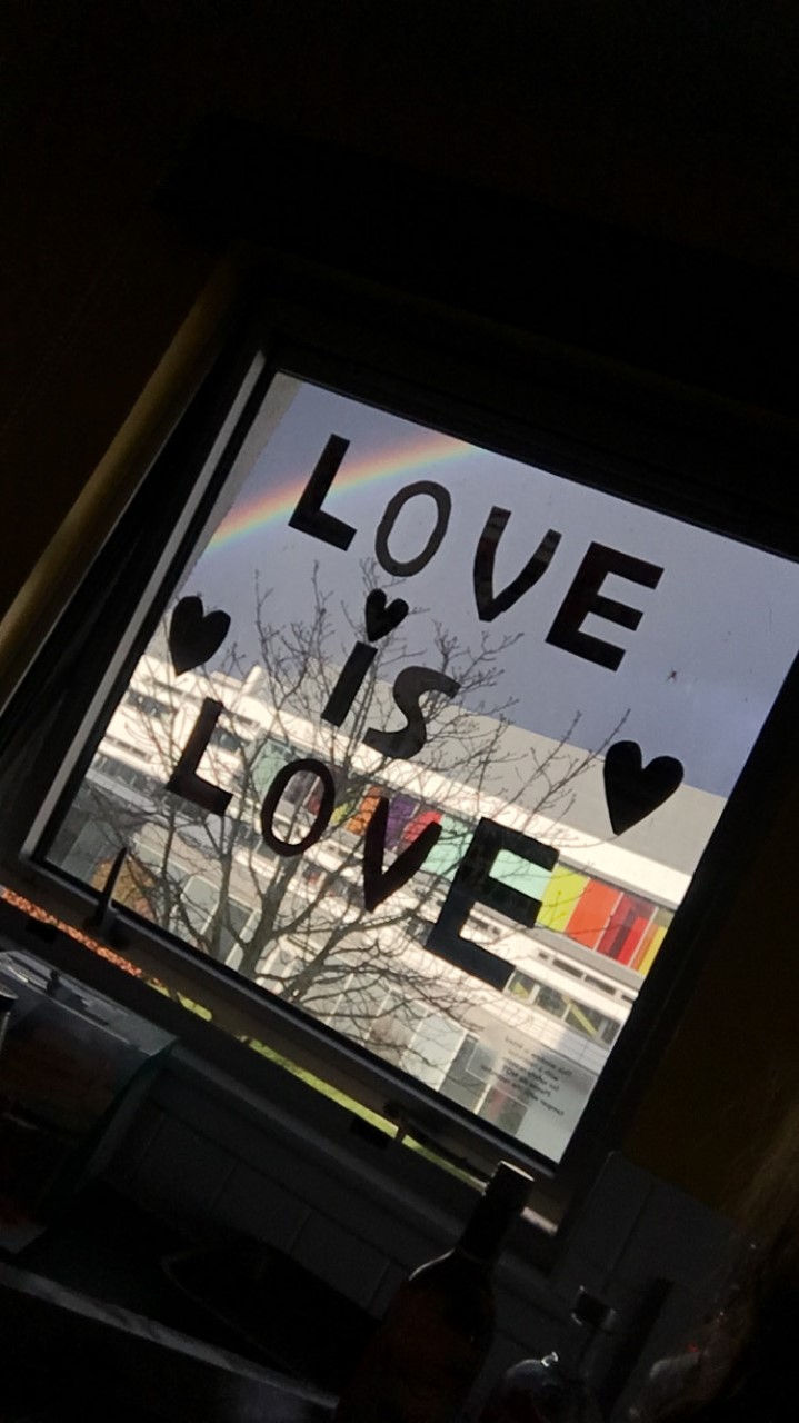 A window with 'Love is Love' written on it