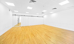 A bright, spacious performance studio with a wall of mirrors at the back, QMU