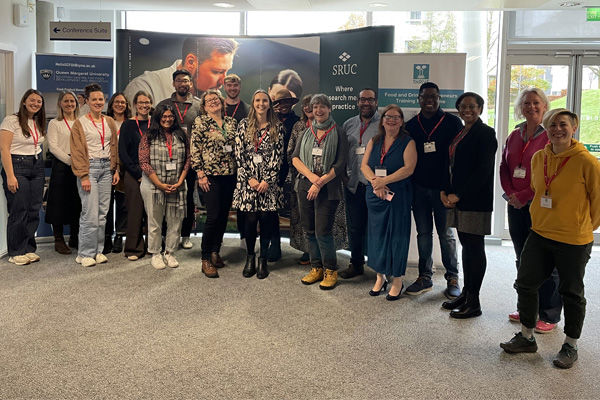 A large group of people post for a photo together at THRIVE 2025