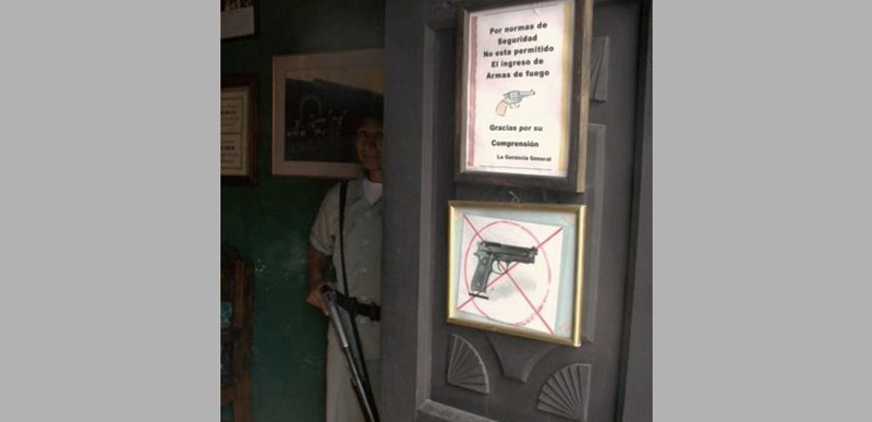 A building in Guatemala with a no gun sign on the door