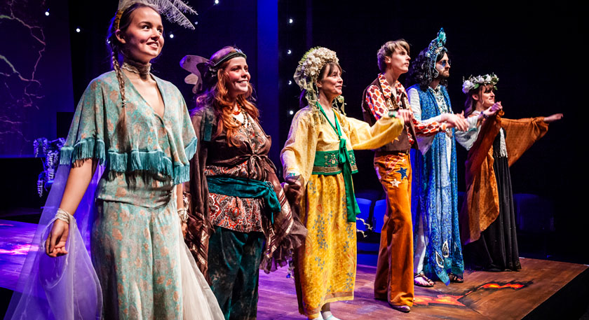 Students on stage in costumes
