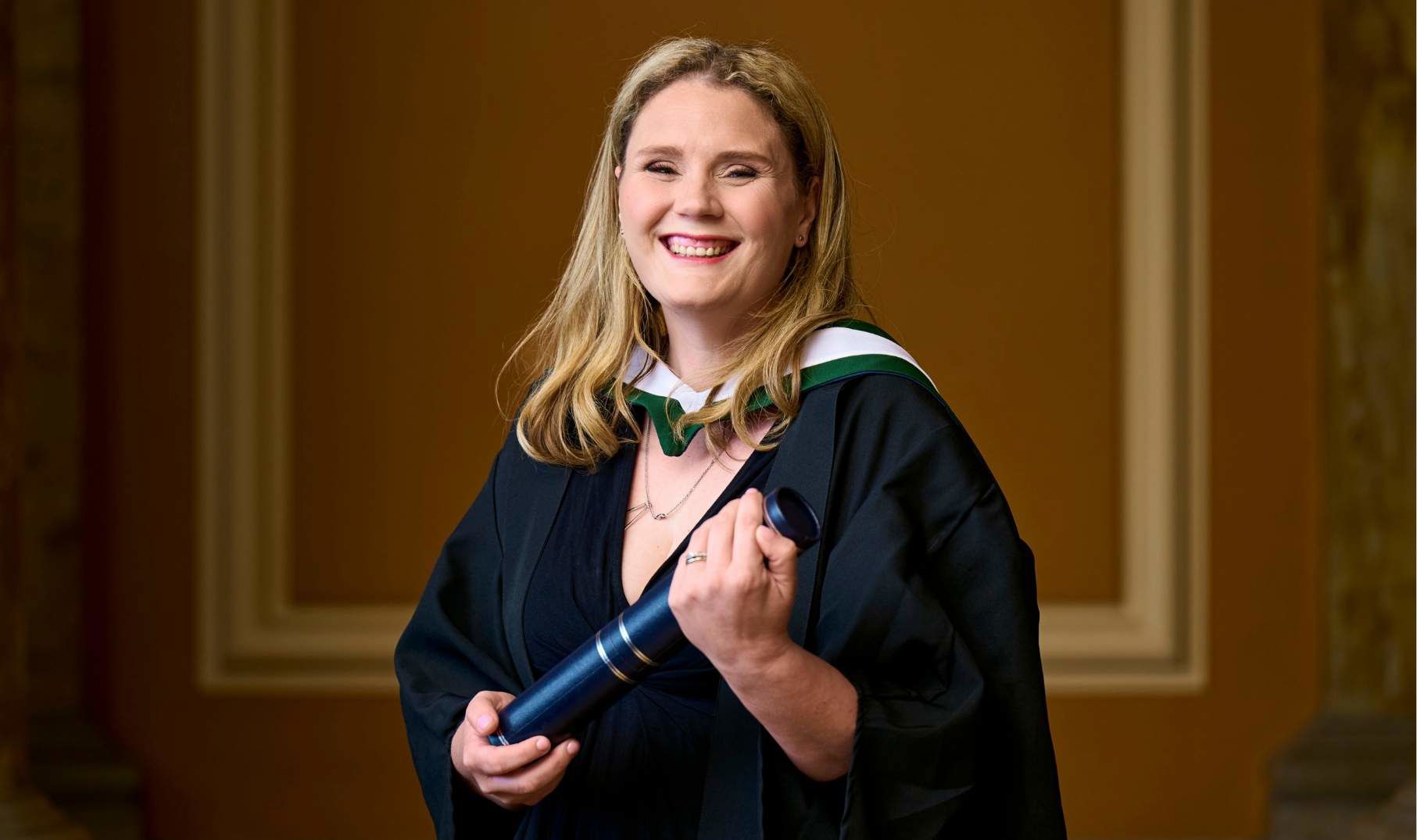Aisling Thomas with scroll at QMU graduation