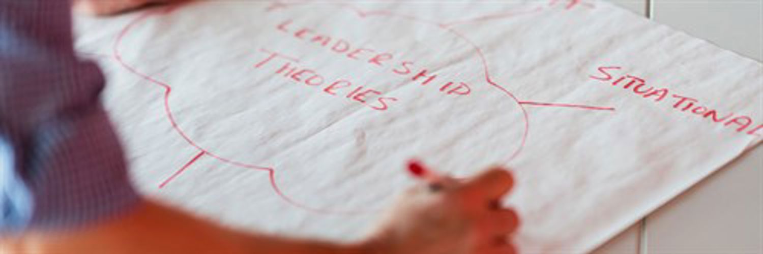 Person creating a spider diagram with ideas relating to leadership