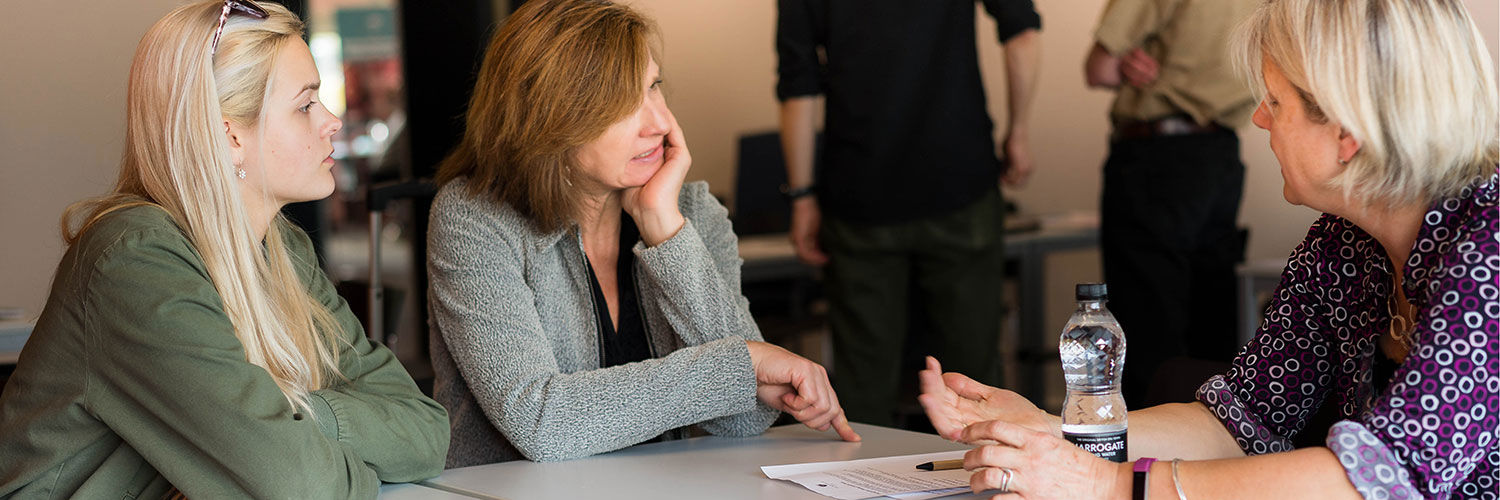 Student and parent discussing complaint with university staff 