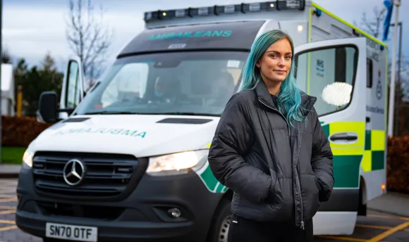 Paramedic Science student standing beside and ambulance