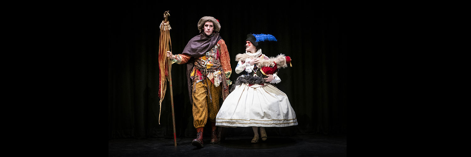 two students dressed on theatrical costumes on stage