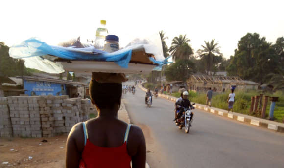 Woman in Kono Sierra Leone carrying supplies on head