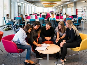Image of students in library working on group project
