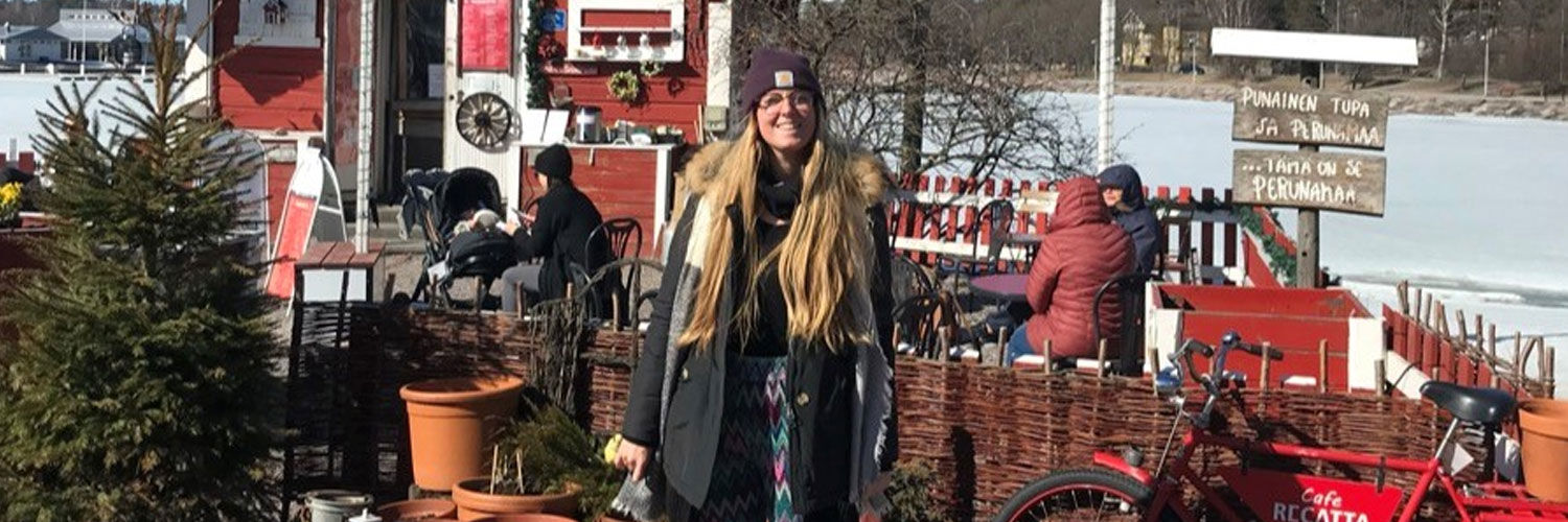 A woman poses for a photo, surrounded by snow