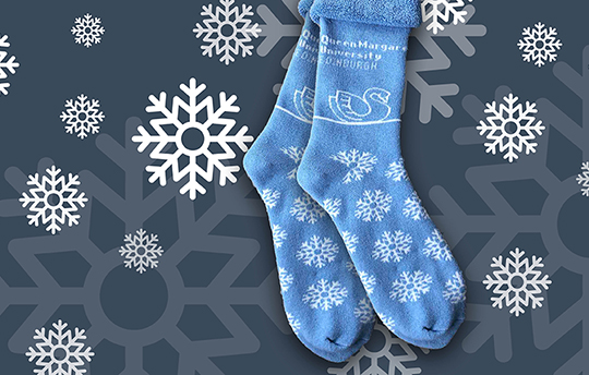 Queen Margaret University branded winter socks with snowflakes