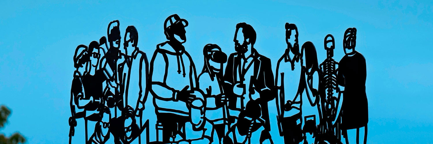 A steel sculpture of linocut-style cutouts of different individuals, as seen through a bright blue sky