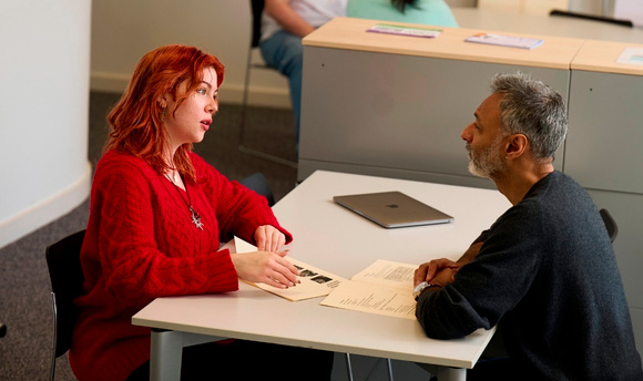 A student sitting and speaking to an advisor from Student Services