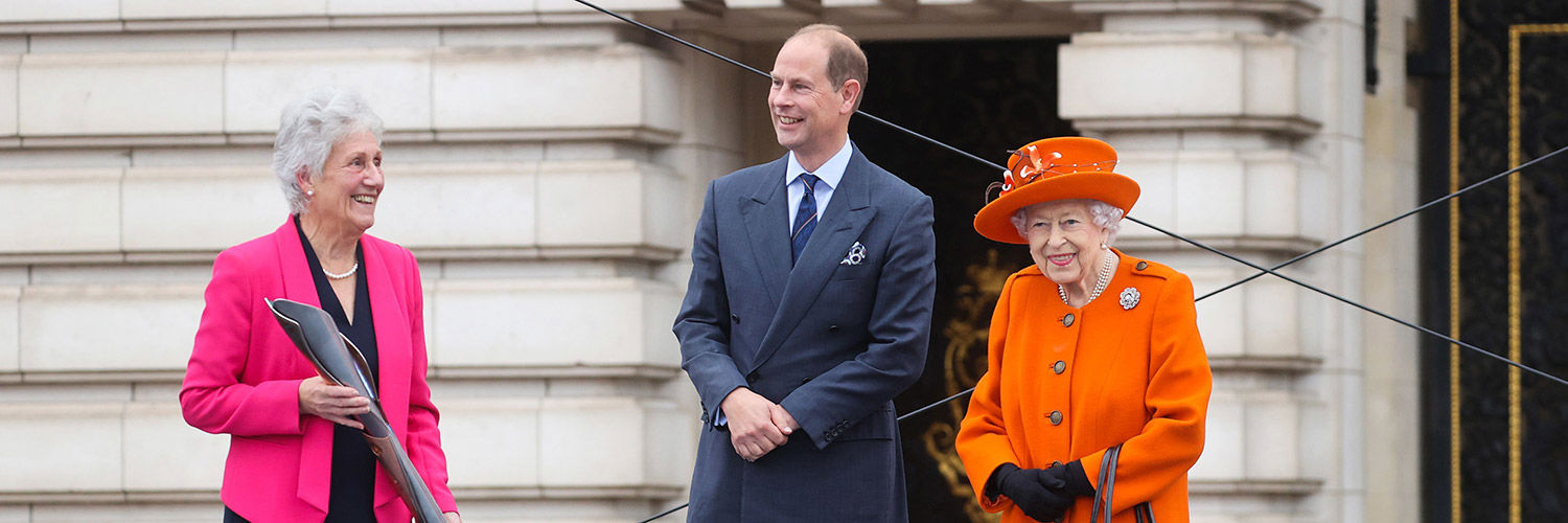 Photo of Dame Louise Martin with Prince Edward, now Duke of Edinburgh, and Queen Elizabeth II.