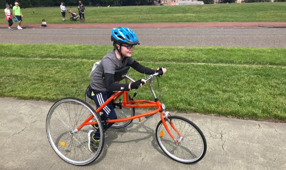 Image of child on frame running bike