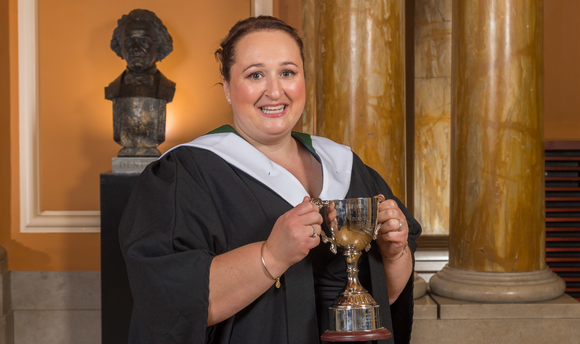 An image of Dean's Prize winning Business Management graduate Gemma Slight holding her trophy.