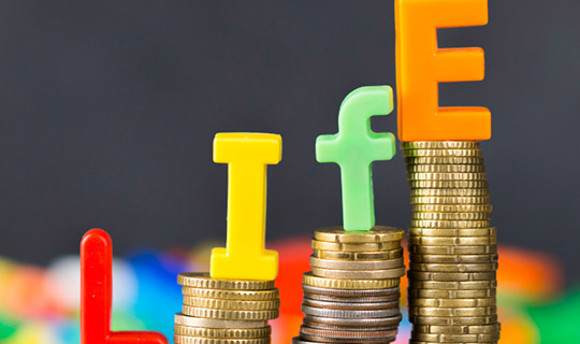 Stacks coins and letters spelling out 'life'