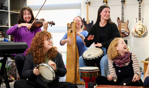 A group of people playing various instruments.
