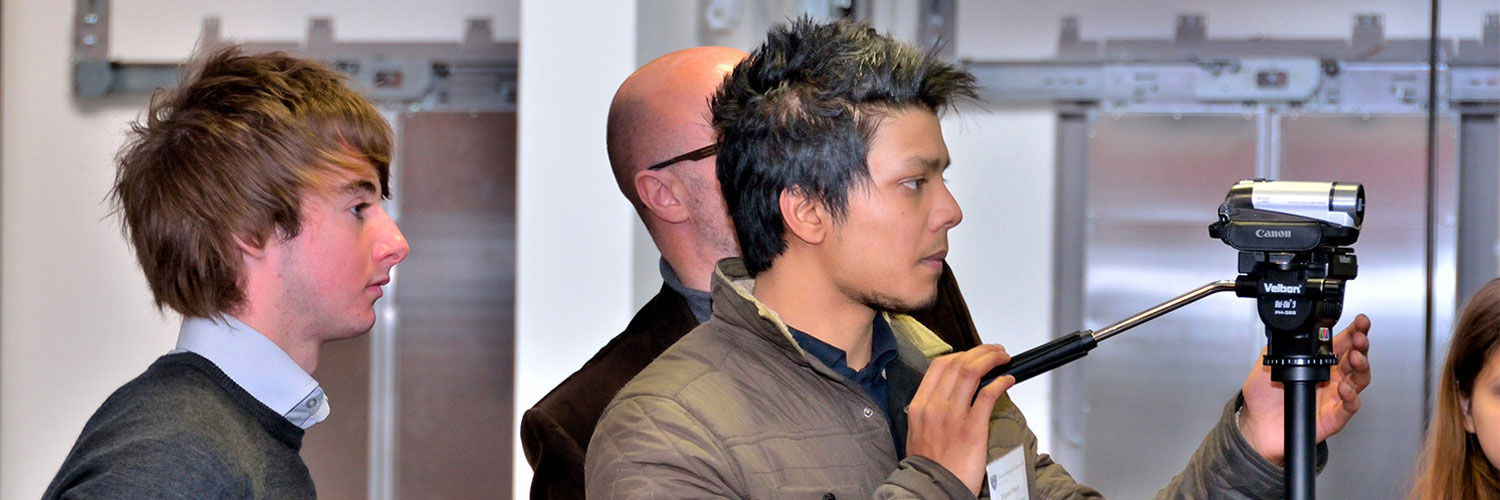 Two students operating a film camera