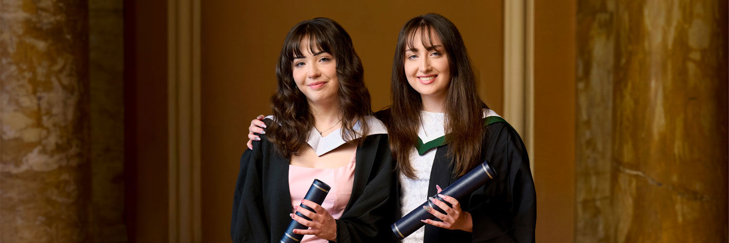Sisters Rachel And Jessica Thorpe in graduation gowns