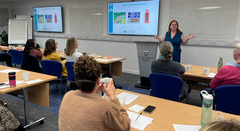 A person presenting on product development to an audience