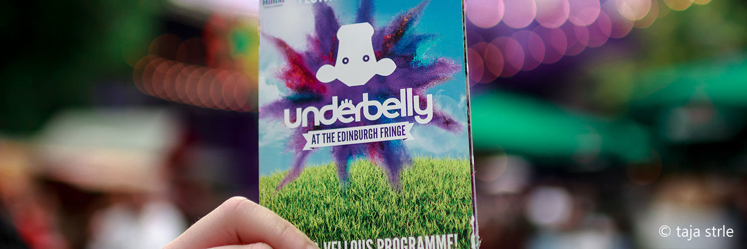 Hand holding up an Underbelly at the Edinburgh Fringe programme