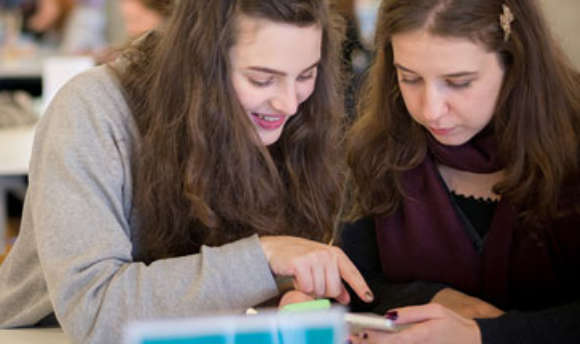 A pair of QMU students working together using a mobile app