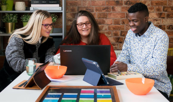 A group of students working away at a laptop