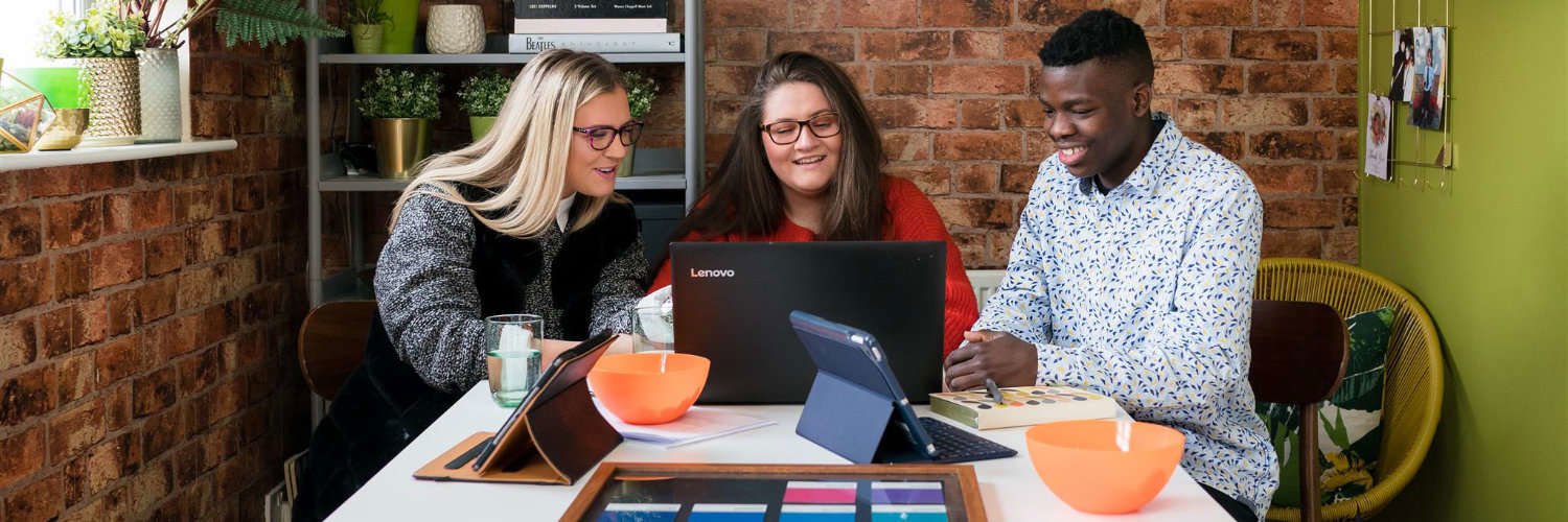 A group of students working away at a laptop