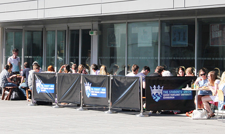 The Queen Margaret University Student Union outdoor seating area full of students