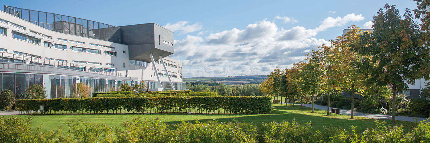 Partial view of Queen Margaret University Campus and grounds on a bright but cloudy day