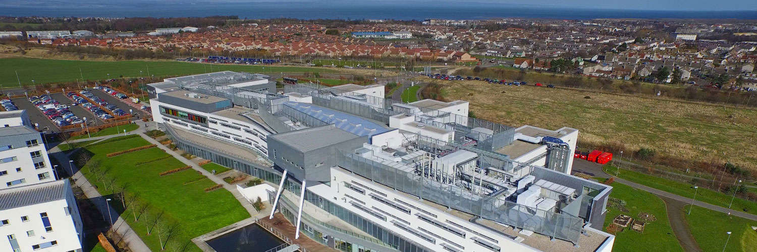 An aerial view of Queen Margaret University Campus with Edinburgh sprawling out beyond it
