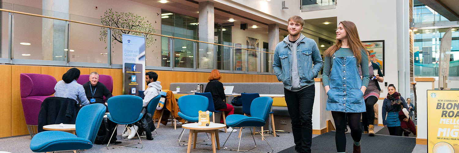 Two Queen Margaret University students walking through the main atrium