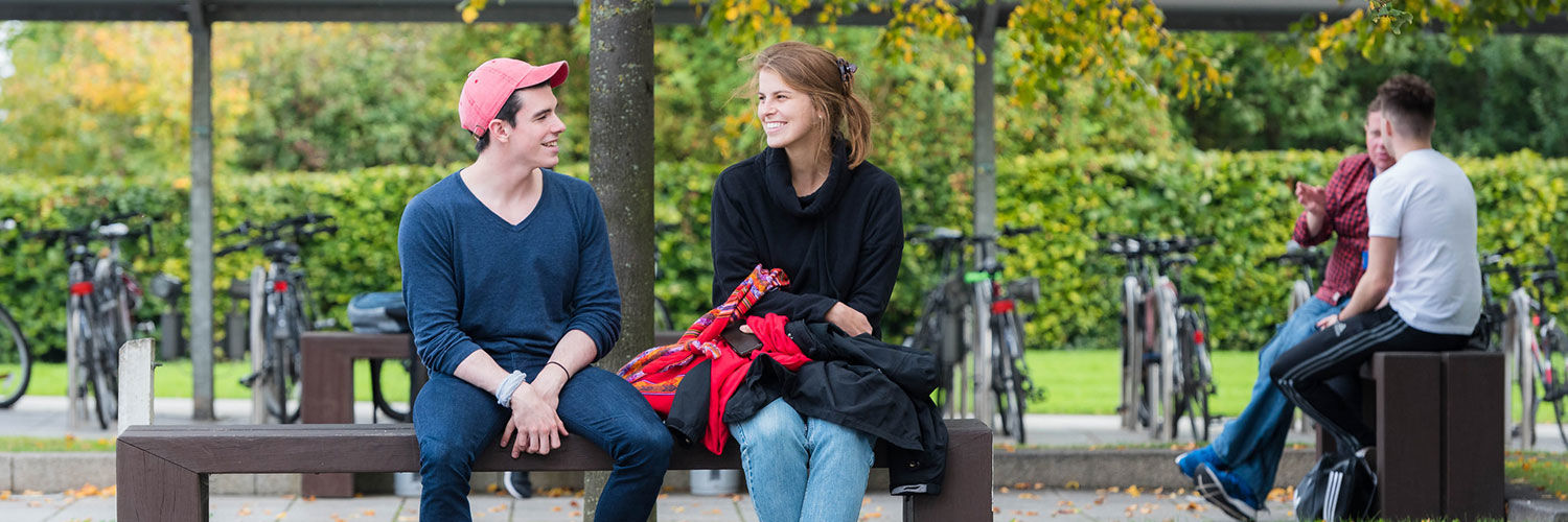 Students talking on the benches outside Queen Margaret University, Edinburgh