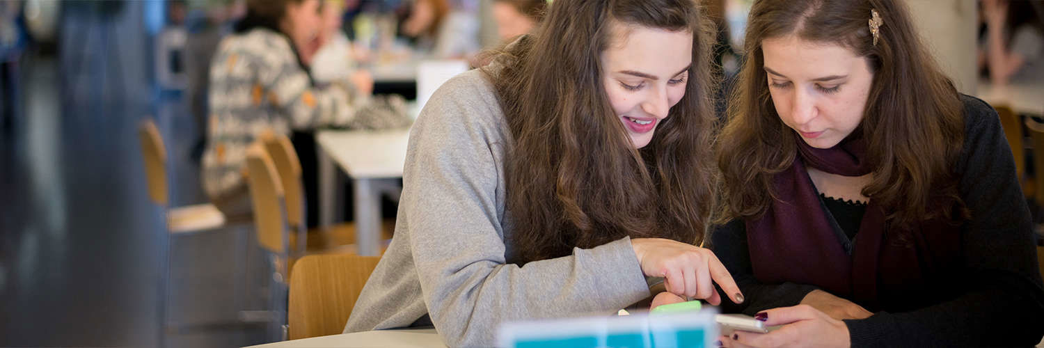 A pair of QMU students working together using a mobile app