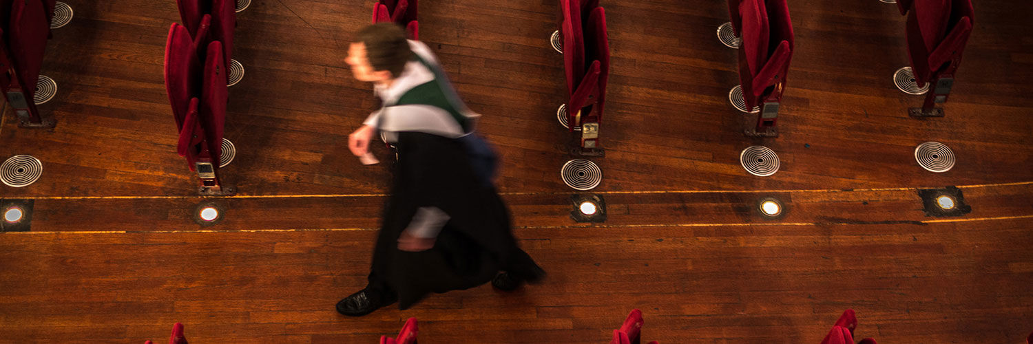 A QMU graduate walking down the aisle at Usher Hall, Edinburgh