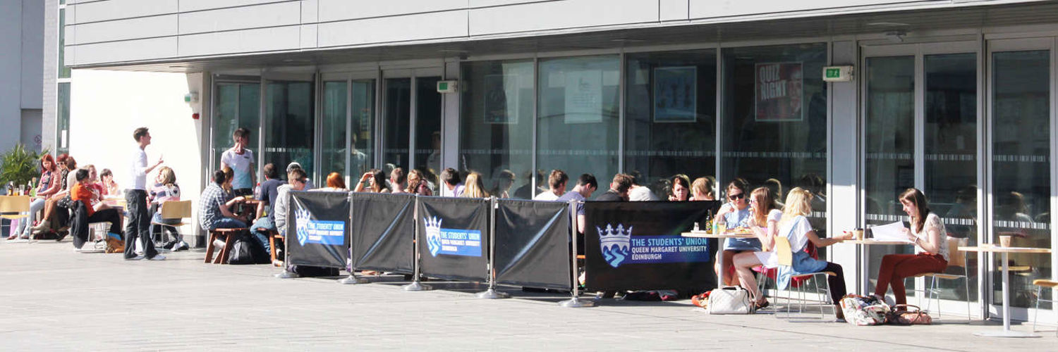 The Queen Margaret University Student Union outdoor seating area full of students