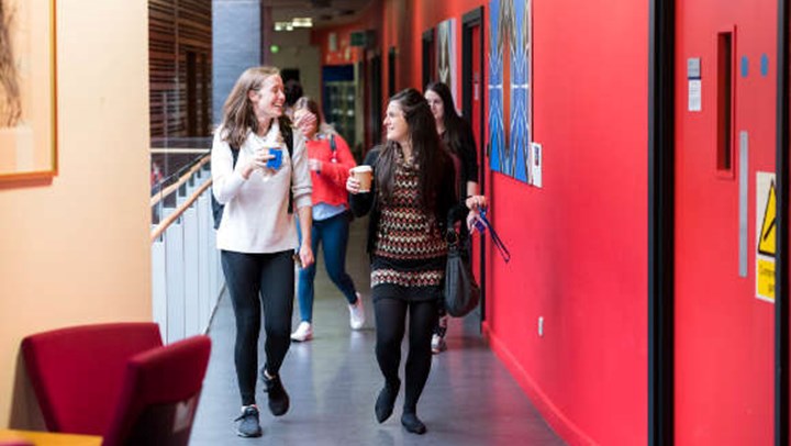 A couple of students walking down the corridor at Queen Margaret University Edinburgh
