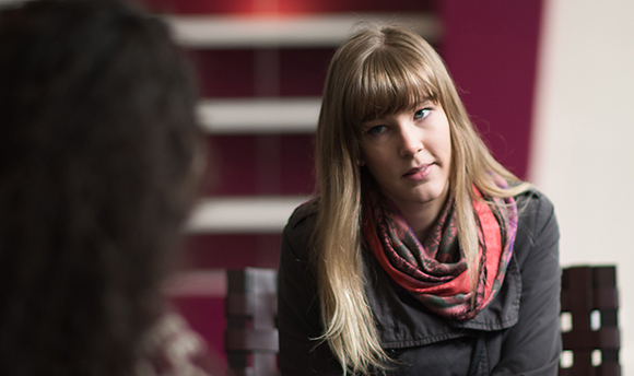 Student listening intently to her fellow student whilst another smiles on, QMU, Edinburgh