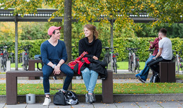 Students talking on the benches outside Queen Margaret University, Edinburgh