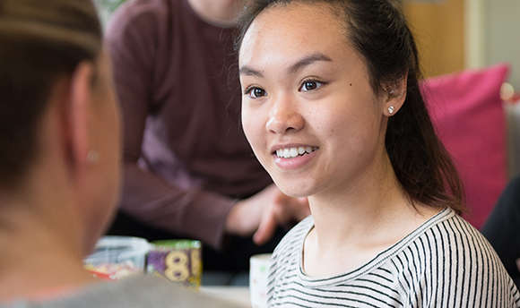 A QMU student talking and smiling
