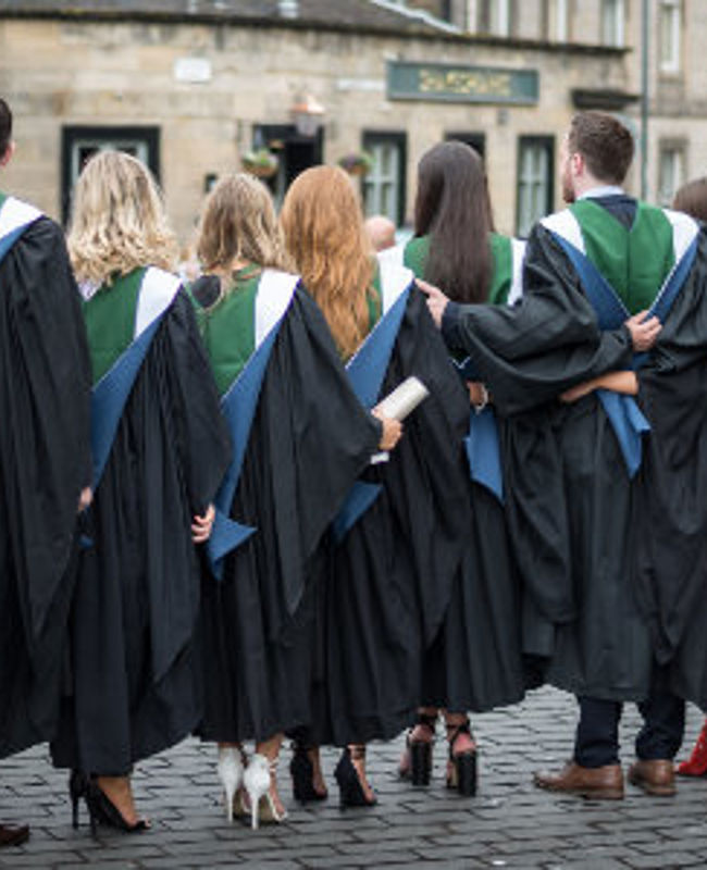 A group of posing QMU Graduates from behind