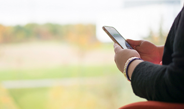 Wide angle view of a person's hands holding their mobile phone
