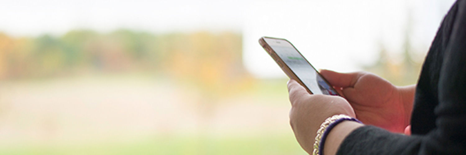 Wide angle view of a person's hands holding their mobile phone
