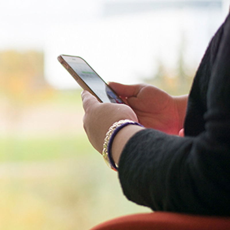 Wide angle view of a person's hands holding their mobile phone