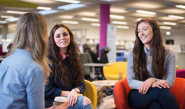 Group of students smiling and talking together, QMU campus, Edinburgh