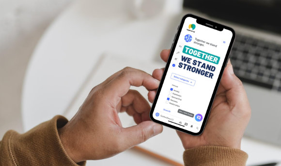 A pair of hands holding a phone and using togetherall
