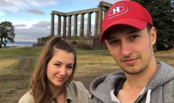 Two happy students posing in front of the National Monument, Edinburgh