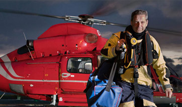 A nurse walking away from a helicopter