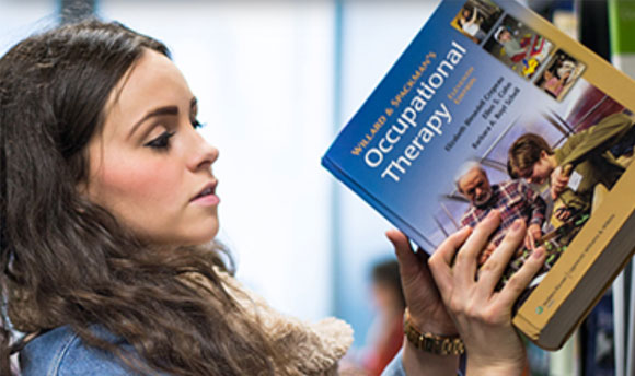 A QMU student fetching an occupational therapy book